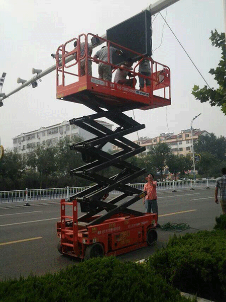 工作人员使用自行式高空作业平台安装交通设施